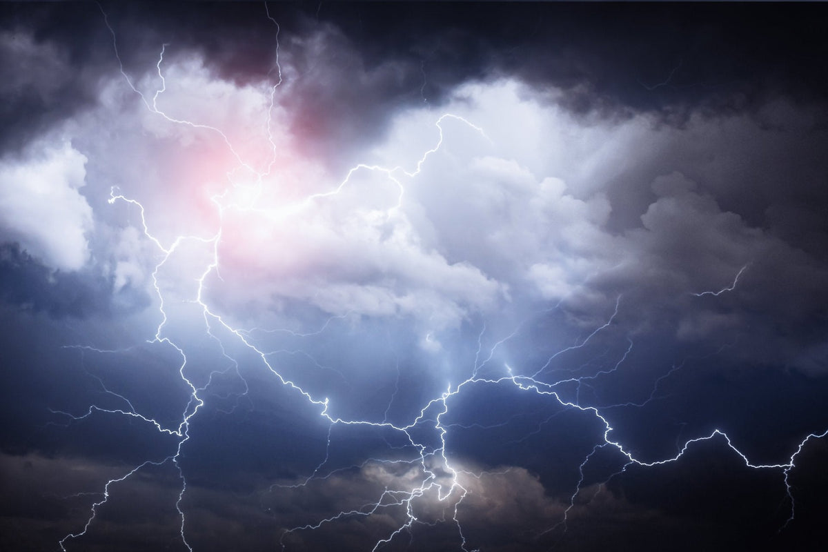 Forked lightning across dark storm clouds at night
